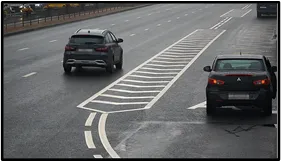 LPR camera view of an SUV and a sedan stopped on a two-lane road next to a hatched no-stopping road marking