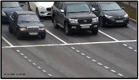 Entry LPR camera view of three SUVs traveling side by side toward the intersection across multiple lanes