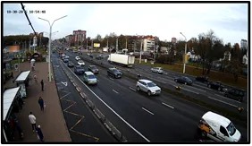 Overview (OV) camera wide shot of a multi-lane roadway with traffic and a timestamp overlay, used to capture the broader scene for evidence