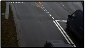 Exit LPR camera view of two dark SUVs having crossed the intersection exit line onto the roadway
