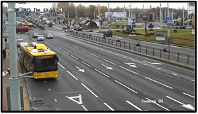 Overview (OV) camera wide shot of a roundabout with a bus and other traffic, labeled Camera 01