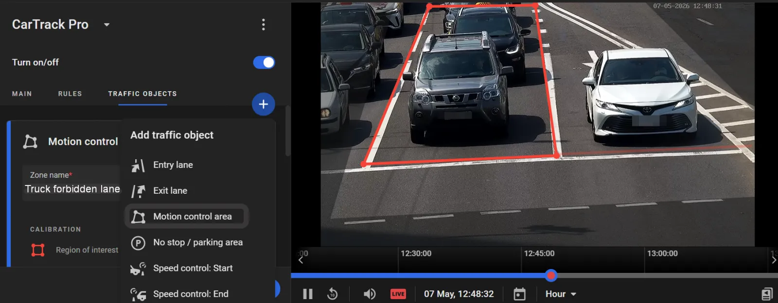 CarTrack Pro Traffic Objects tab with a Motion control area named Trucks forbidden lane drawn over a traffic lane in the camera view